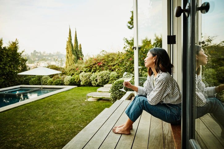 woman in backyard of house KrlPrb.width .jpg