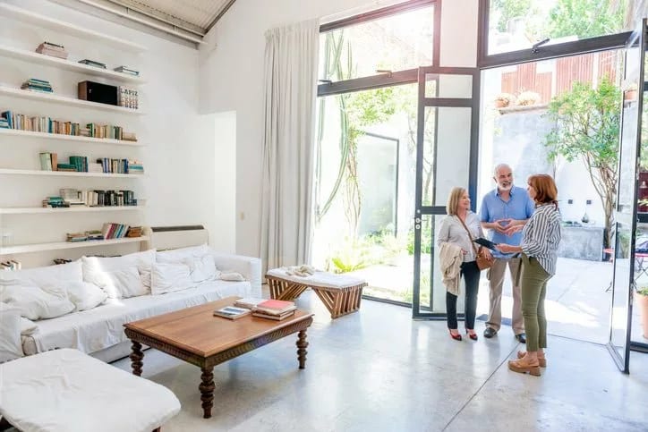 couple with realtor in living room ScGOTEJ.width .jpg