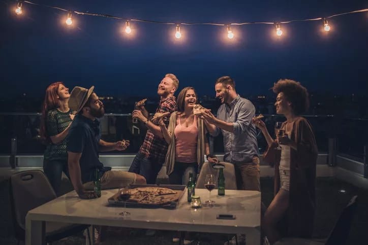 friends eating pizza and beer at rooftop part.width pMowu.jpg