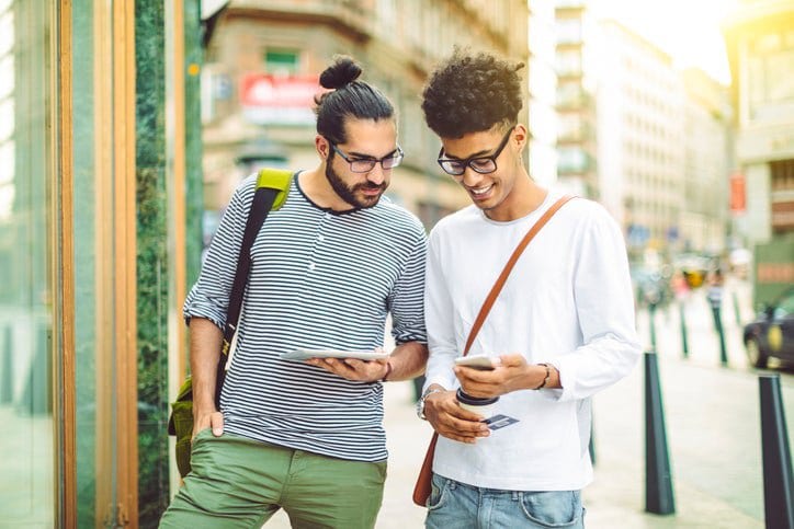 two men outside with phone and credit card Fh.width .jpg