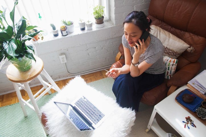 woman on phone with credit card and laptop y.width .jpg