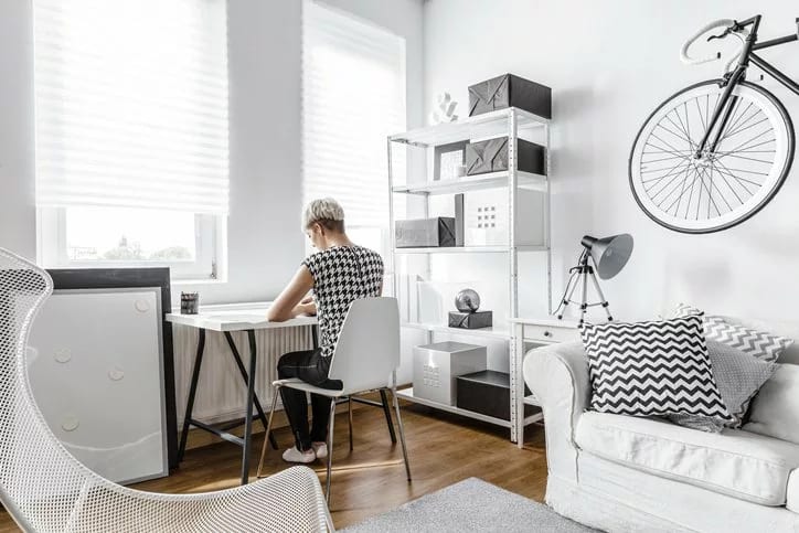 young woman at desk in small apartment.width .jpg