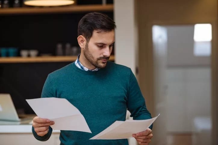 man holding papers zXjSvlk.width .jpg