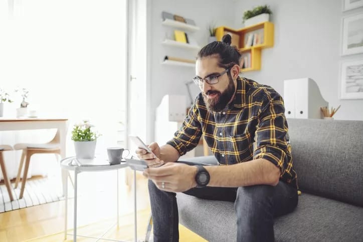 man holding phone and credit card GXOd.width .jpg