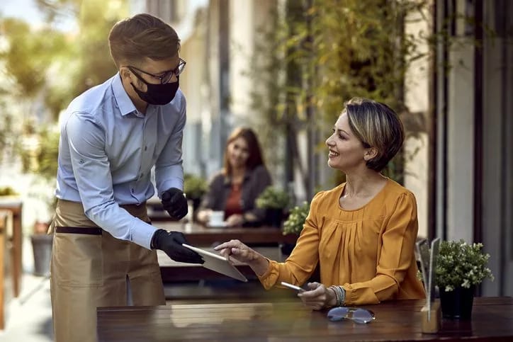 waiter and woman at restaurant.width .jpg