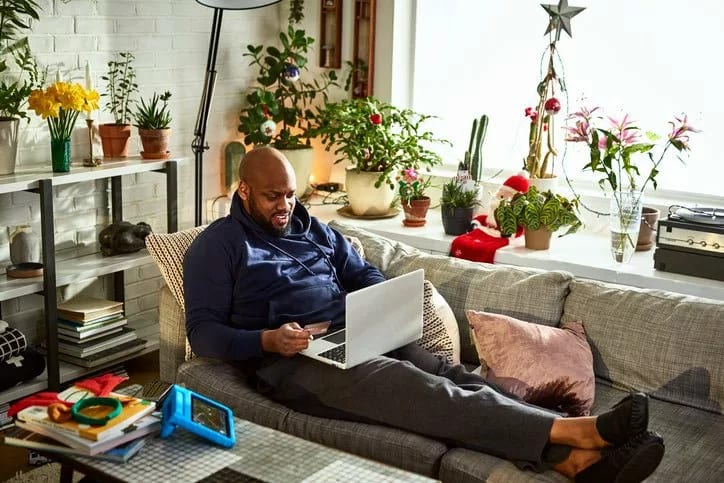 man on couch with laptop and credit card wnWu.width .jpg
