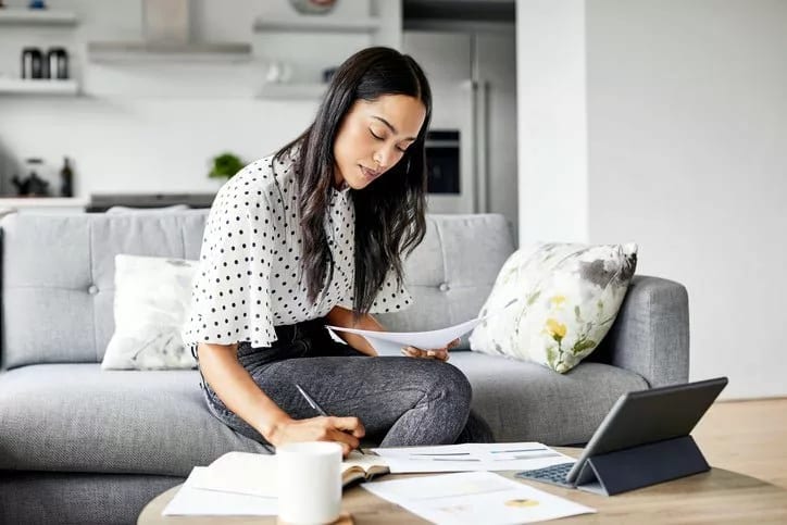 woman on couch with papers and tablet hBtEvpP.width .jpg