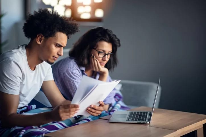 worried couple with bills and laptop.width .jpg