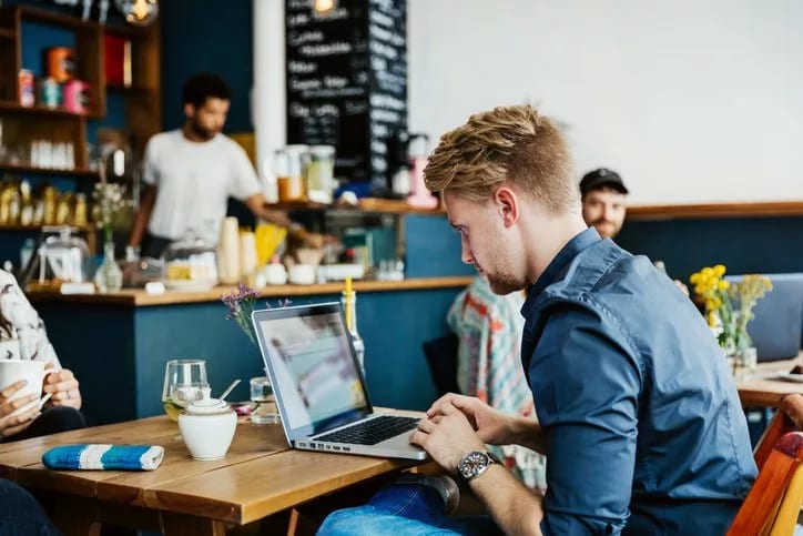 man on laptop in cafe AhCu.width .jpg