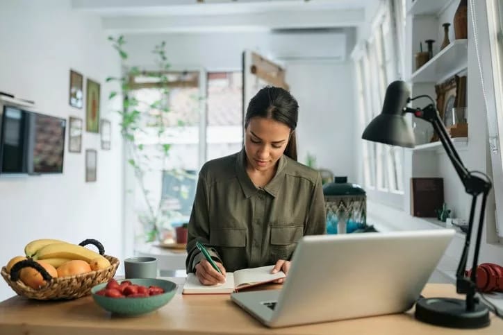 woman in kitchen writing in notebook hdcQtAk.width .jpg