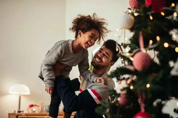 dad and daughter decorating christmas tree.width .jpg
