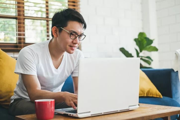 man on couch with laptop.width .jpg