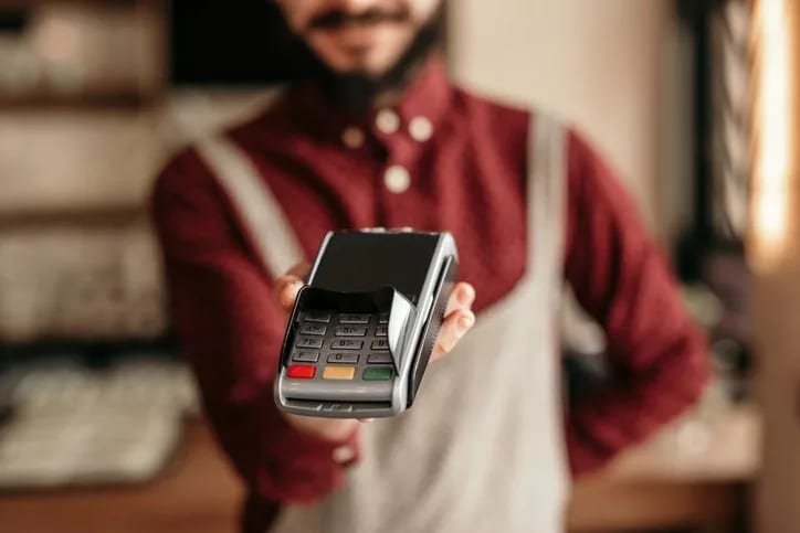 waiter holding credit card reader.width .jpg