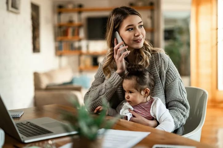 woman on phone with baby on lap LfSMd.width .jpg
