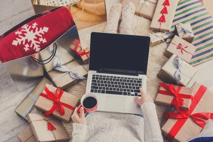 woman with laptop and holiday gifts.width .jpg