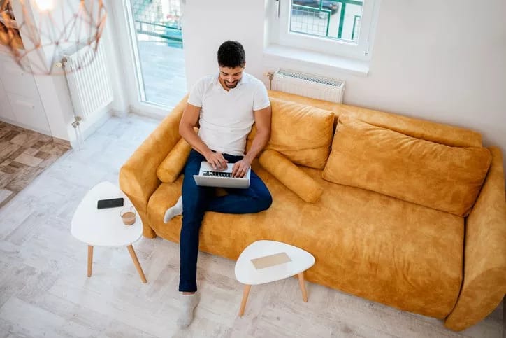 man on laptop on couch.width .jpg