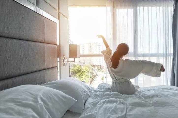 woman waking up in hotel.width .jpg