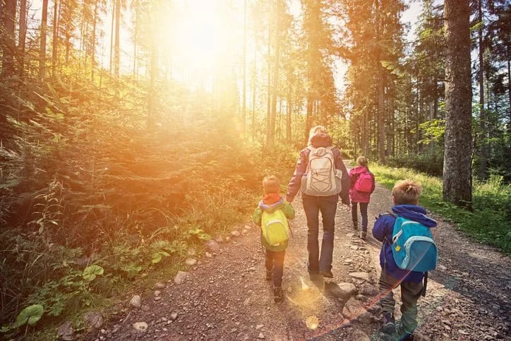 mom and kids hiking in forest AuytLy.width .jpg