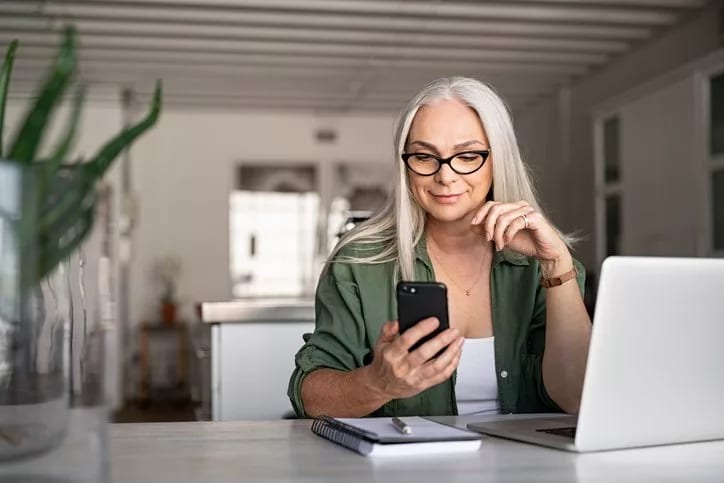 woman with phone and laptop at home.width loP.jpg