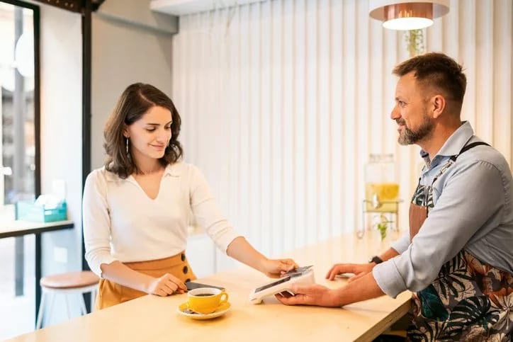 woman paying with credit card cafe BImCnBL.width .jpg