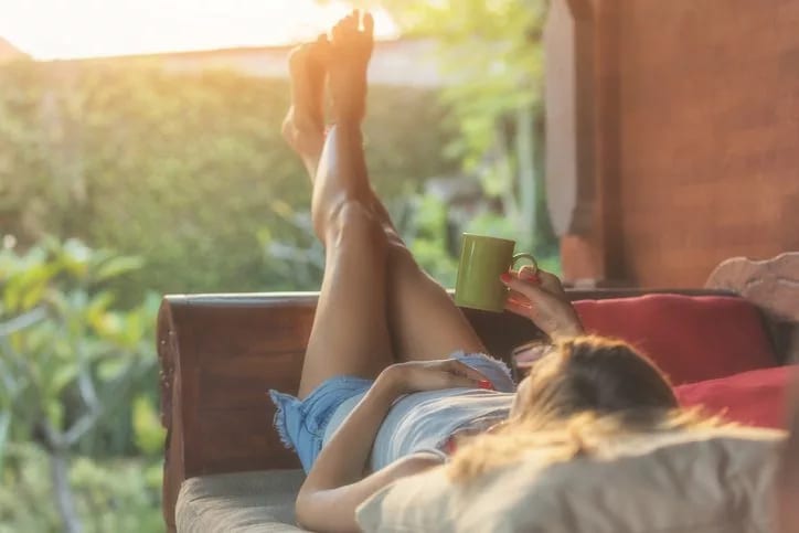woman laying on patio with coffee.width .jpg