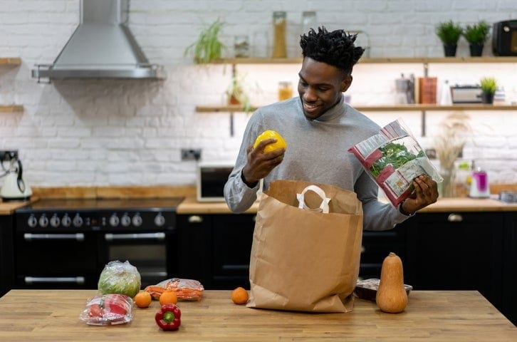 man in kitchen with groceries GPjuoM.width .jpg