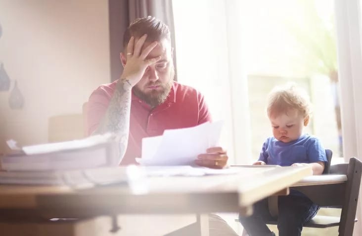 man with baby and papers at dining table.width .jpg