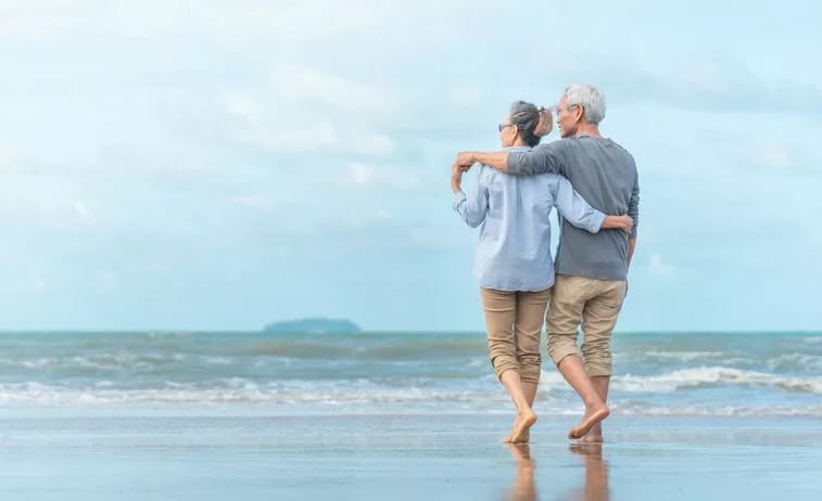 older couple walking beach.width .jpg