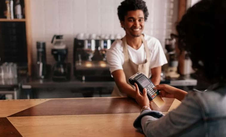 woman paying cafe cashier with credit card.width .jpg
