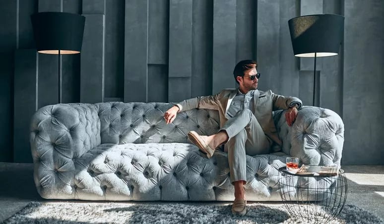 man in suit on fancy couch.width .jpg