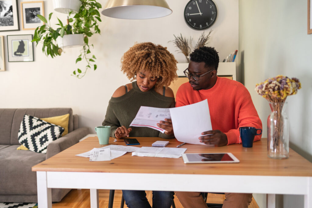 couple reviewing papers budgeting