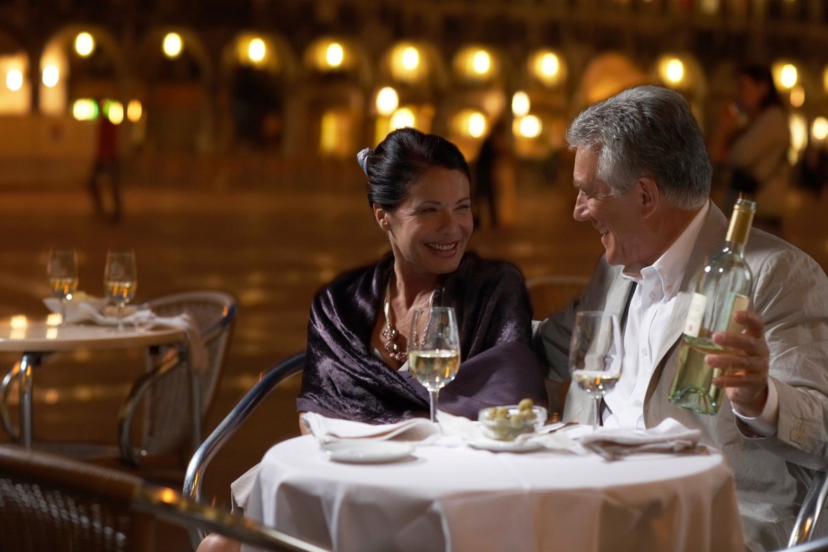 Well dressed mature couple enjoying wine with.width Uwlolj.jpg