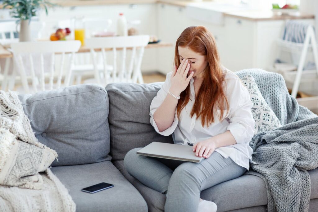 Woman rubbing the bridge of her nose appearin.width UGzXRBl.jpg