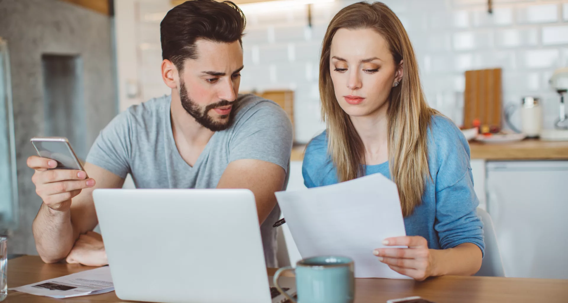 young couple looking over finances at home.jpg