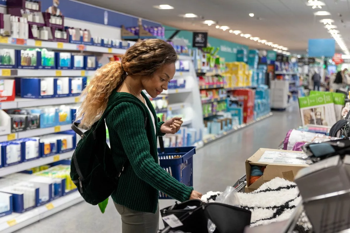 Consumer shopping with basket in a discount s.width .jpg