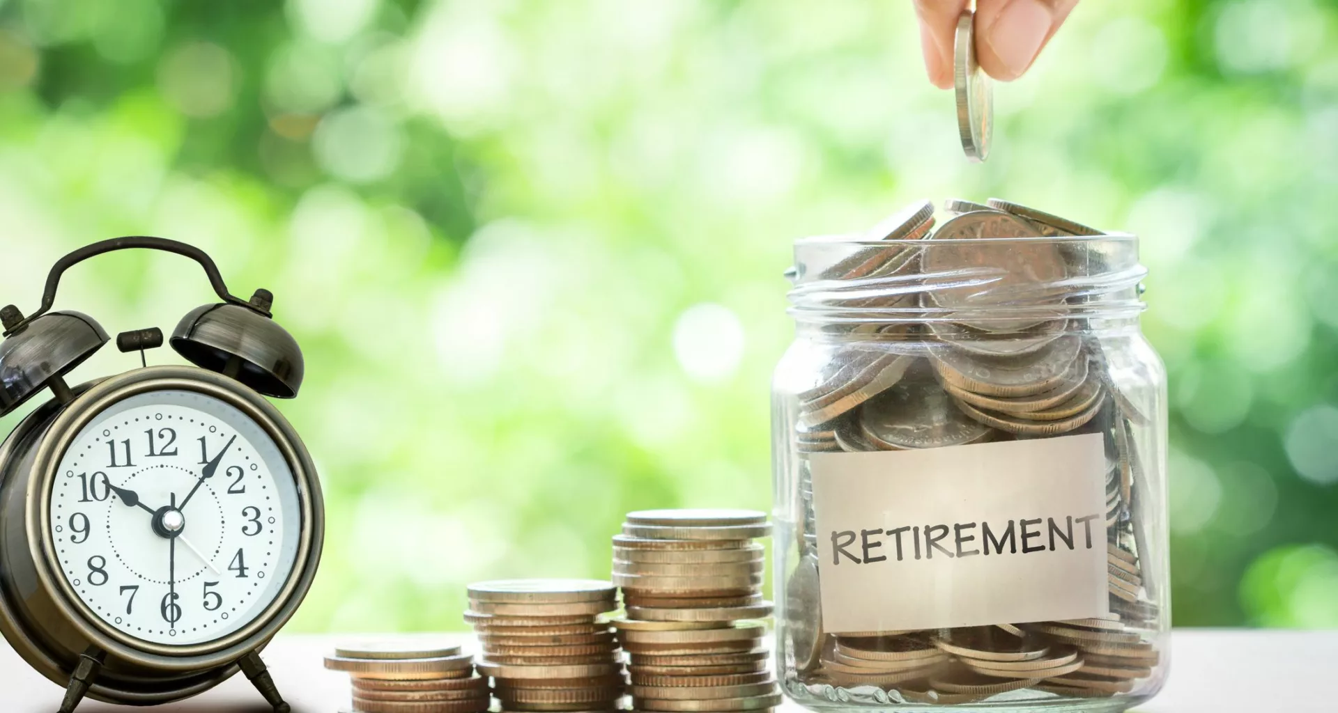 retirement savings jar full of coins and alarm clock .jpg