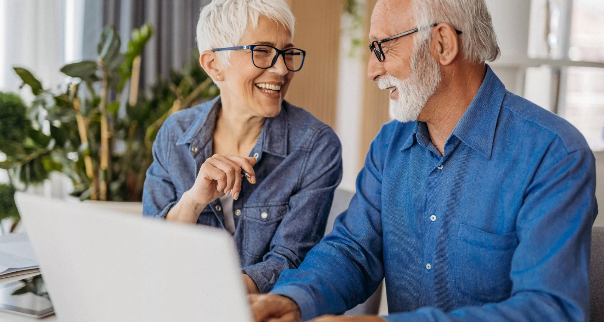 senior couple at laptop smiling gettyimages .jpg