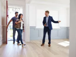 couple viewing house with realtor.width .jpg