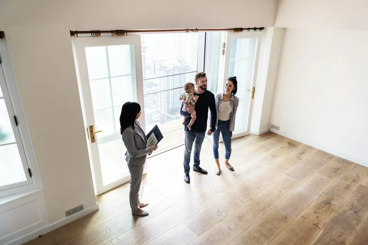 family viewing new house with realtor.width .jpg