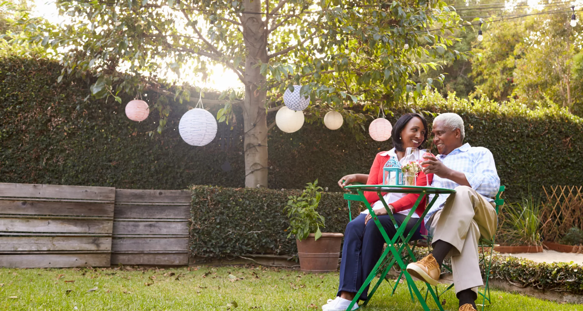 mature couple relaxing drinking wine together in their backyard.jpg
