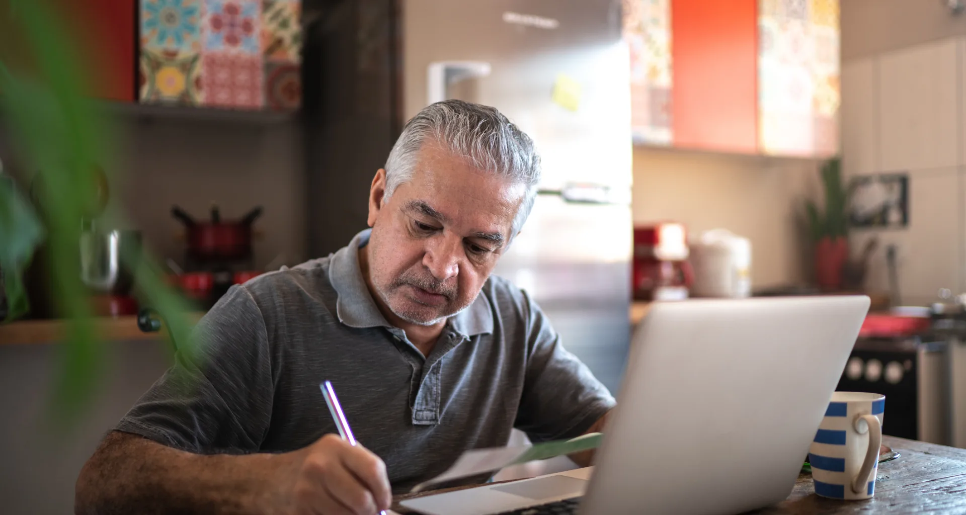 senior man laptop taking notes gettyimages .jpg